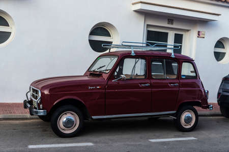 Fornells, Spain - July 20, 2021: Garnet Renault 4 Super car with roof rack parked on a street in Fornells, Menorca, Balearic island, Spainのeditorial素材