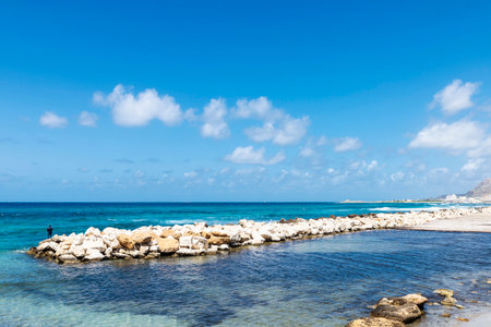 Beach and a man on the groyne of Marsala, Trapani, Sicily, Italy,の写真素材