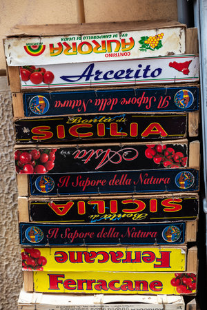 Monreale, Italy - May 12, 2023: Pile of empty wooden boxes of sign of fruits and vegetables on a street in Monreale, Palermo, Sicily; Italyのeditorial素材