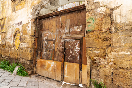 Old cracked wooden door on a street of the old town of Palermo, Sicily, Italyの写真素材