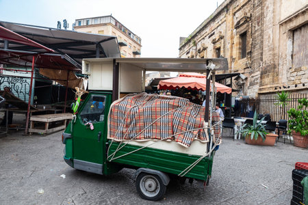 Palermo, Italy - May 13, 2023: Piaggio tricycle parked in Ballaro Market, street food market with...