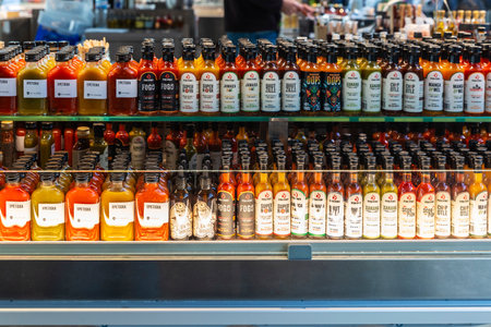Porto, Portugal - November 23, 2023: Piri piri and O Petiska hot sauce bottles in a gourmet store in...