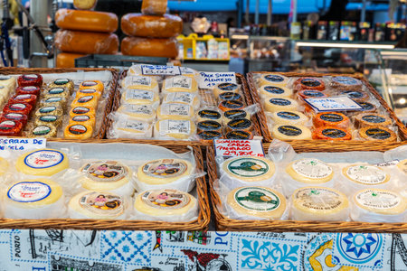 Porto, Portugal - November 23, 2023: Cow, sheep and goat cheese shop in Bolhao Market, street food market in Porto or Oporto, Portugalのeditorial素材
