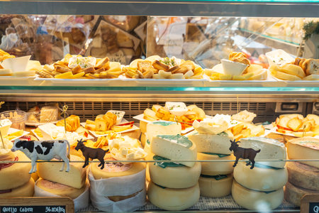 Porto, Portugal - November 23, 2023: Cow, sheep and goat cheese shop in Bolhao Market, street food market in Porto or Oporto, Portugalのeditorial素材