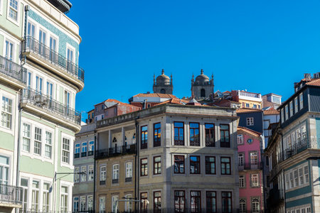 Facade of old classic buildings decorated with tiles and the bell towers of the cathedral in the old...