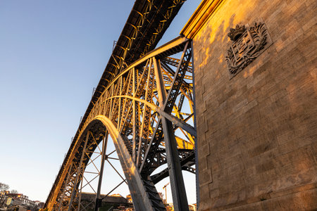 View of the Dom Luis I bridge over the Douro river at sunset in Porto or Porto, Portugal