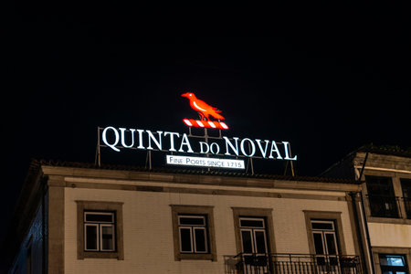 Porto, Portugal - November 24, 2023: Illuminated logo and sign of the Quinta do Noval cellar, brand of Port wine, at night in Vila Nova de Gaia, Porto or Porto, Portugalのeditorial素材