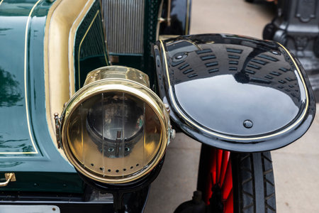 Golden headlight of an old retro car from the 1920s parked on a street in Barcelona, Catalonia, Spainの写真素材