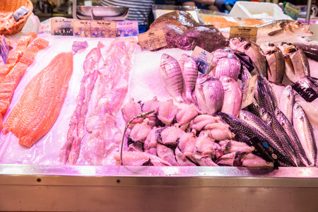 Fresh fish, turbot, red mullet, salmon, black bream, red porgy and monkfish tail in a fish shop in Les Halles Market, street food market in Narbonne or Narbonne, Occitanie, Franceの写真素材