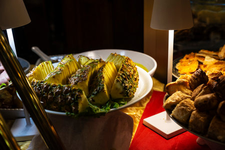 Display of a bar with a tray with a pineapple cut into pieces in Turin or Torino, Piedmont, Italyの写真素材