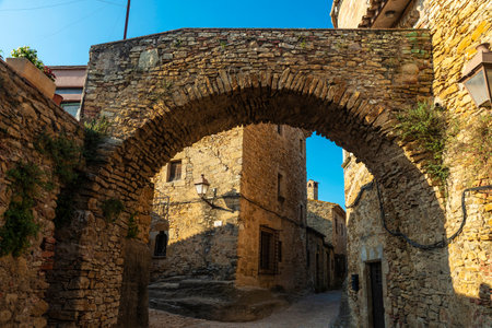 Narrow street with typical houses of the rustic village of Peratallada, Girona, Catalonia, Spainの写真素材