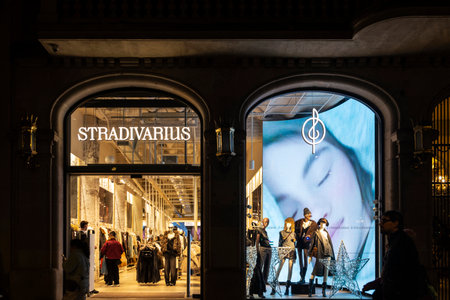 Barcelona, Spain - November 25, 2025: Sign of a Stradivarius clothing store with people around at...