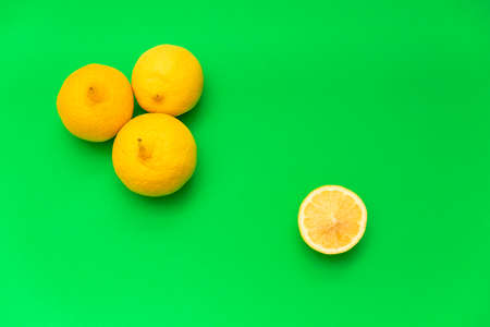 group of six yellow lemons (fruit) and two halves. blue background. studio photo.の写真素材