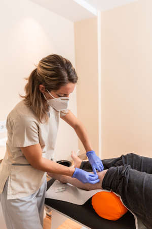 physiotherapist giving treatment with dry needling to patientの写真素材