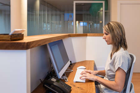 young woman at the reception of fitness club or health centreの写真素材