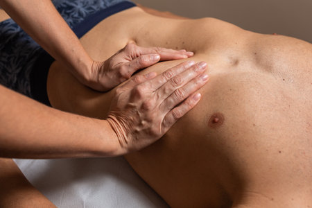 Woman physiotherapist does session to man. visceral ostropathyの写真素材