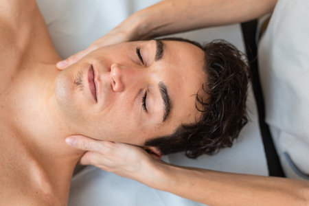 Woman physiotherapist does session to man. manual Massage therapy, cervical painの写真素材