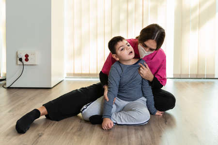 physiotherapist works with disabled child, cerebral palsy.の写真素材