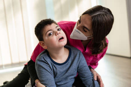 physiotherapist works with disabled child, cerebral palsy.の写真素材
