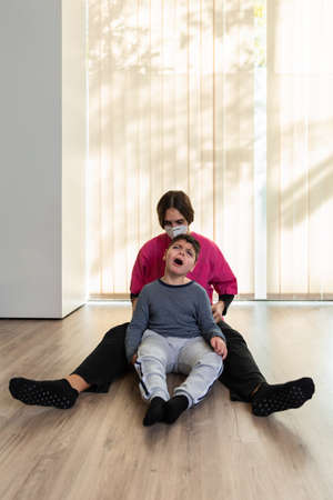 physiotherapist works with disabled child, cerebral palsy.の写真素材