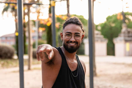 african american athlete boy greets smiling camera in a park.の写真素材