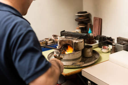 blowtorch melts silver in a jewelry workshop furnaceの写真素材