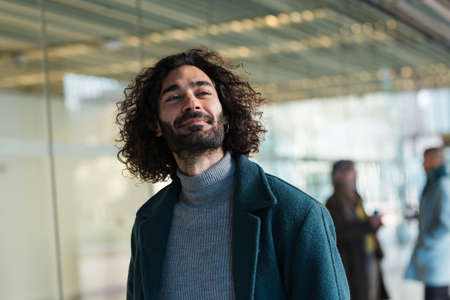 Glad Hispanic businessman on street before workの写真素材