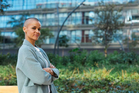 Confident business woman posing outdoors with her arms crossed in the financial district.の写真素材