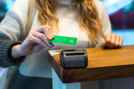 Woman paying with credit card via terminal