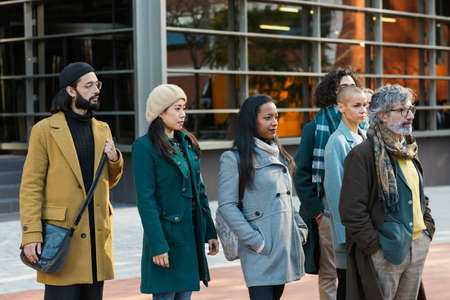 Group of serious businessmen and women standing looking forwardの写真素材