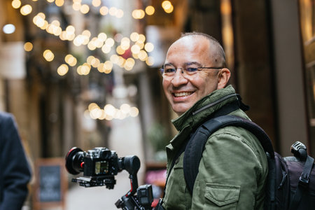 Professional Videographer with Camera and Gimbal Stabilizer in Urban Settingの写真素材