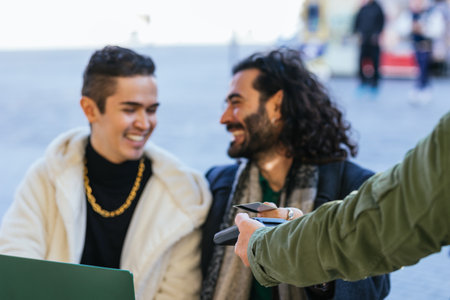 Man handing credit card to waiter to pay restaurant bill.の写真素材