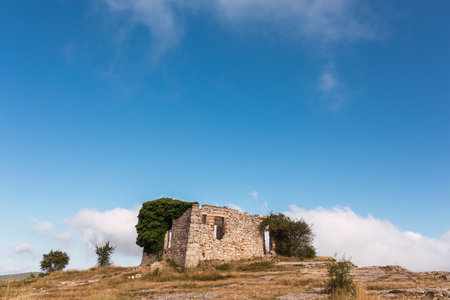 ruins of a house in La Mussara ,Tarragona, Spain, above everything on a hill with a cliffの写真素材