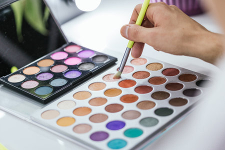 Person using a colorful make-up palette in backstageの写真素材