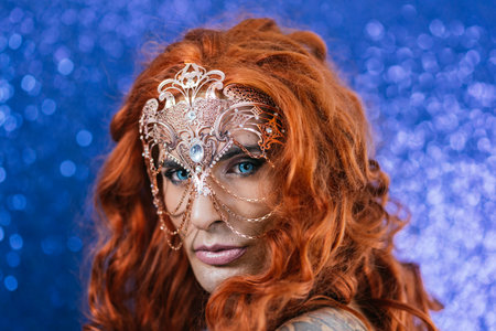 Confident drag queen with blue eyes wearing a fancy maskの写真素材