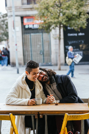 Happy gay couple in love enjoying a date outdoors in a cafe.の写真素材