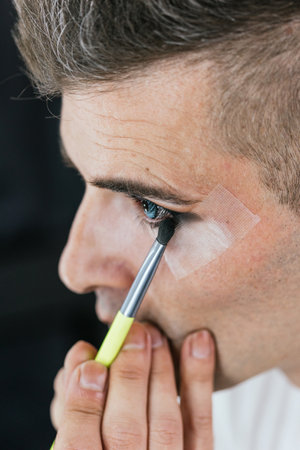 Close-up of a gay man making up the eyesの写真素材