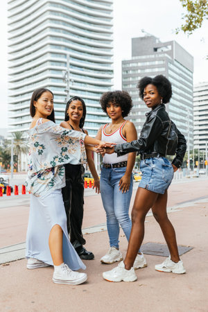 Group of diverse woman and transgender person holding handsの写真素材