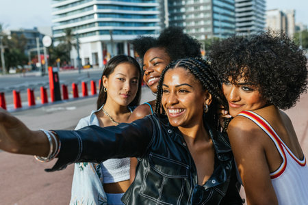 Women and transgender person taking a selfie in the cityの写真素材