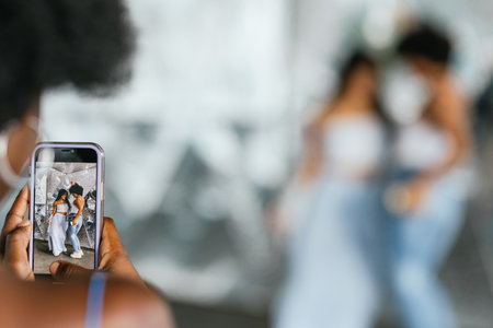 Mobile screen while women recording a video dancing outdoorsの写真素材