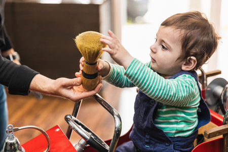 Toddlers first haircut experience at barbershopの写真素材