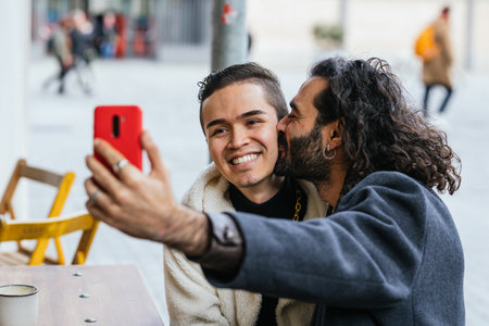 Affectionate gay couple taking a selfieの写真素材