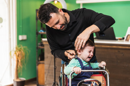 Childs first haircut at barbershopの写真素材