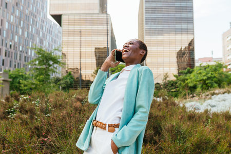 Joyful businesswoman on a phone call outdoorsの写真素材