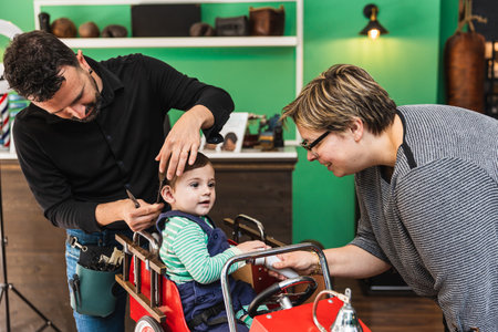 Toddlers first haircut at barbershopの写真素材