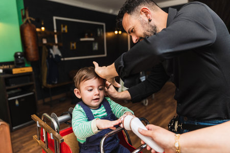 Little boys first haircut at barbershopの写真素材