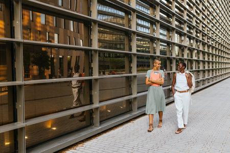 Businesswomen chatting on city streetの写真素材
