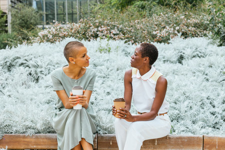Businesswomen enjoying coffee break in gardenの写真素材
