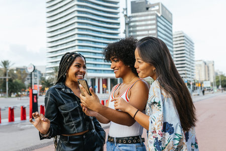 A transgender woman spends time with her female friends on a city street.の写真素材