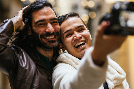 Two happy men taking a selfie while smiling and having funの写真素材